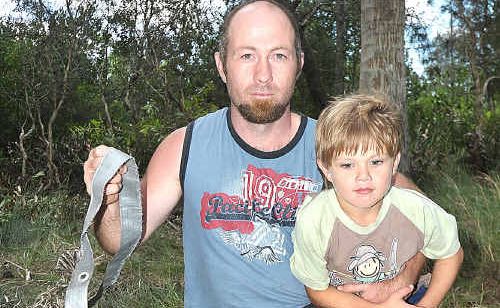 Greg McDonald with son George and the ripped remains of the campsite where the incident occured on Saturday morning. Greg McDonald with son George and the ripped remains of the campsite where the incident occured on Saturday morning.